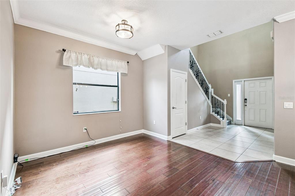 11737 Crestridge Loop New Port Richey, FL 34655 - Photo 17 of 100 an empty room with wooden floor and windows