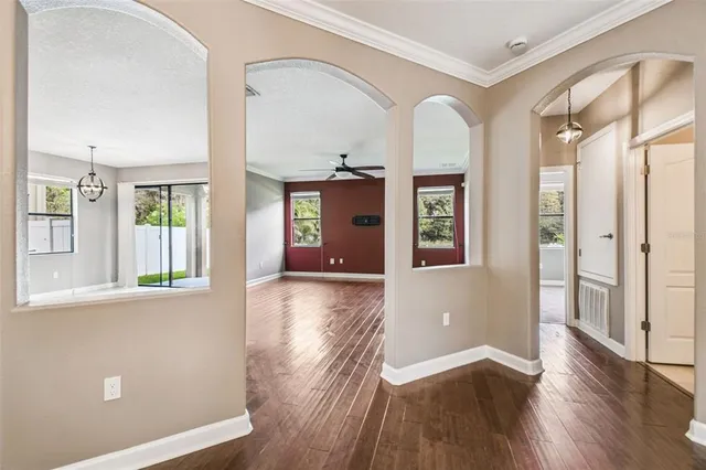 a spacious bathroom with a granite countertop double vanity sink a mirror and a bathtub