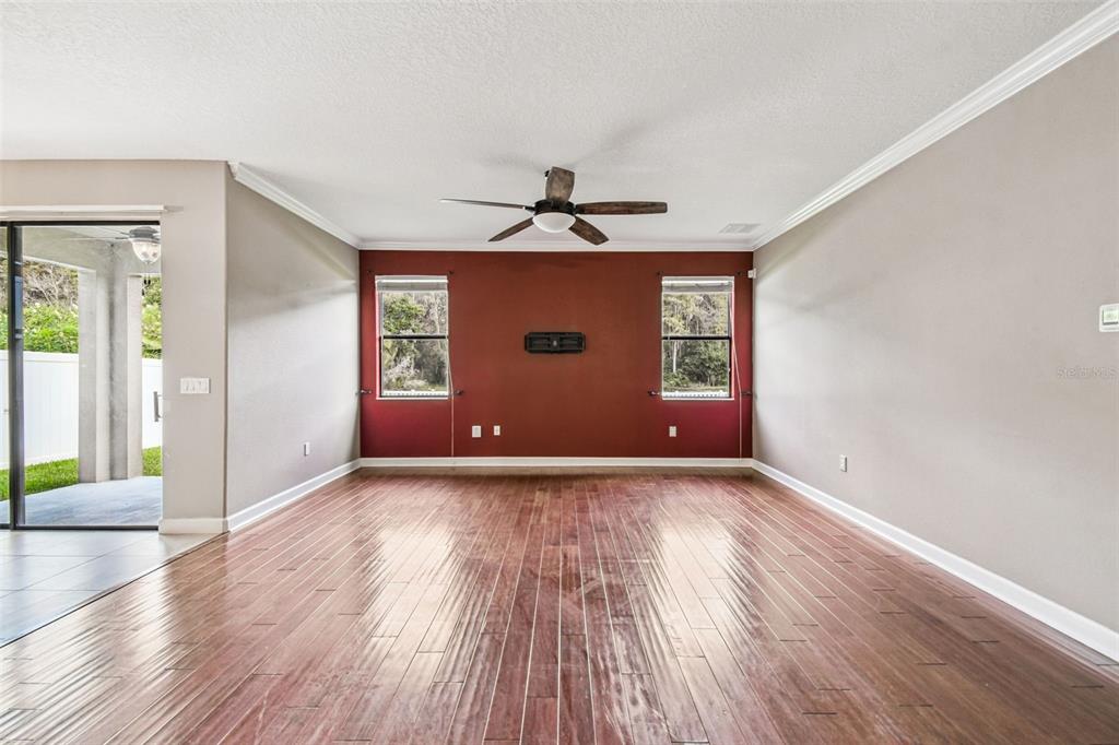 11737 Crestridge Loop New Port Richey, FL 34655 - Photo 23 of 100 a view of an empty room with window and wooden floor