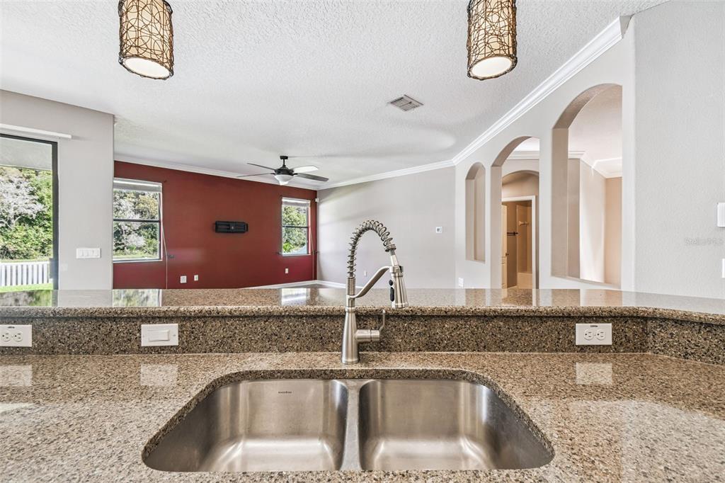 11737 Crestridge Loop New Port Richey, FL 34655 - Photo 34 of 100 a kitchen with a sink and a large mirror