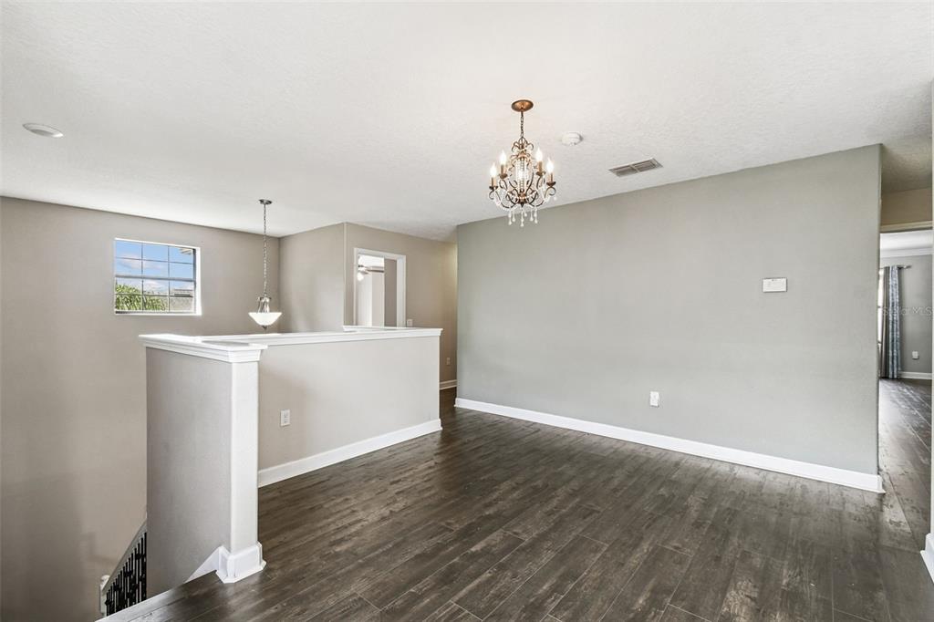 11737 Crestridge Loop New Port Richey, FL 34655 - Photo 37 of 100 a view of a kitchen with a sink and dishwasher in white cabinet with wooden floor