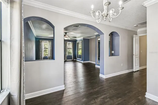 a front view of a house with a yard and potted plants