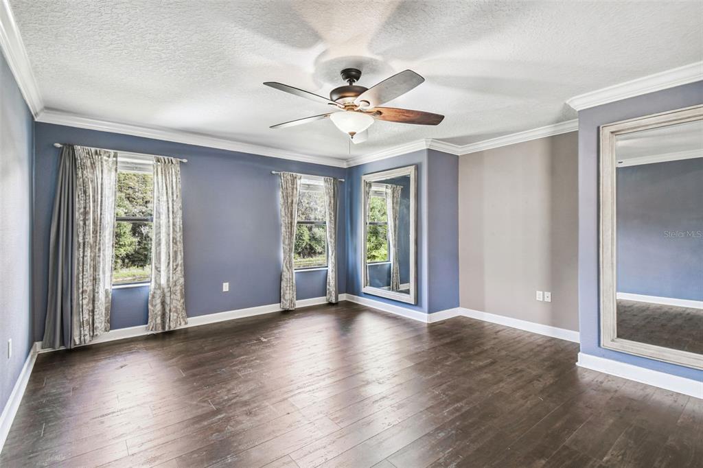 11737 Crestridge Loop New Port Richey, FL 34655 - Photo 44 of 100 a view of an empty room with wooden floor and a window