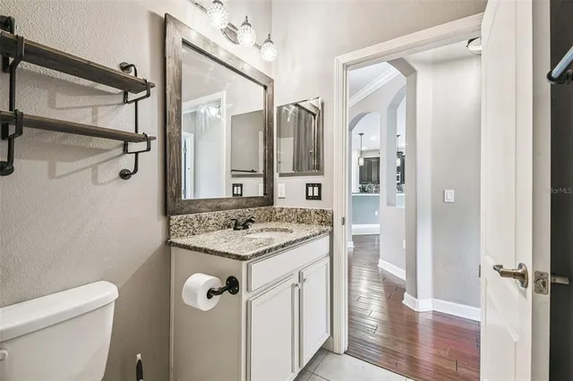 a view of a house with a big yard and a large tree