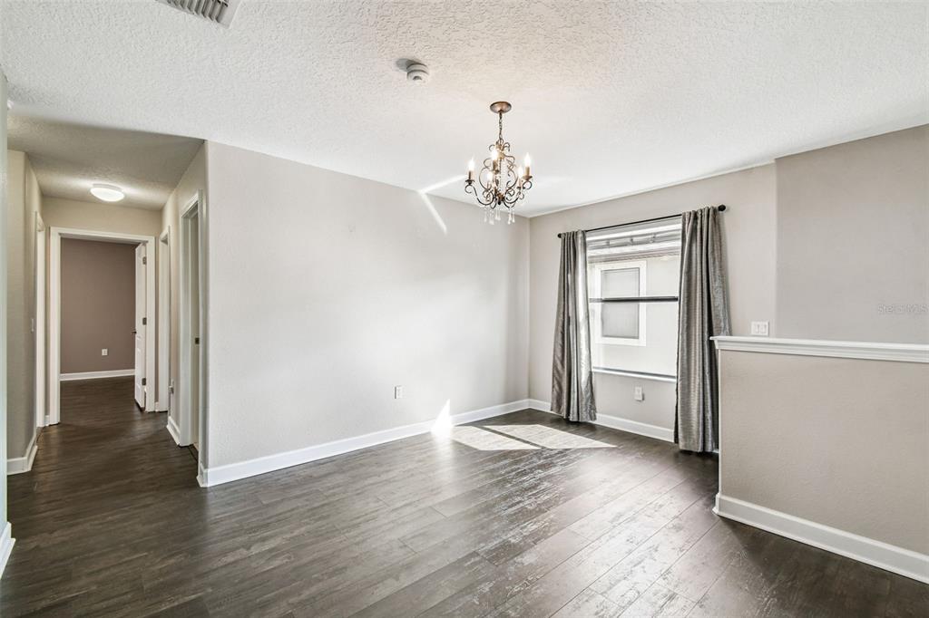 11737 Crestridge Loop New Port Richey, FL 34655 - Photo 53 of 100 an empty room with wooden floor and windows