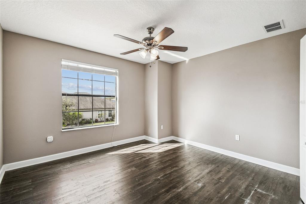 11737 Crestridge Loop New Port Richey, FL 34655 - Photo 56 of 100 an empty room with wooden floor fan and windows