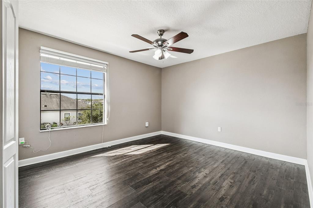 11737 Crestridge Loop New Port Richey, FL 34655 - Photo 60 of 100 an empty room with windows and fan