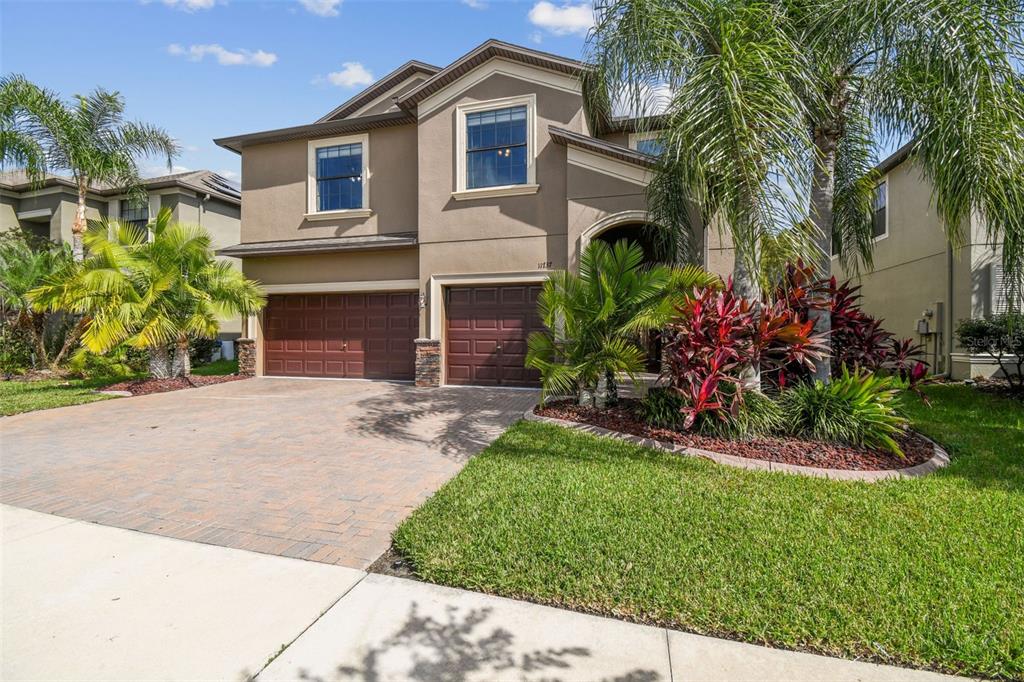 11737 Crestridge Loop New Port Richey, FL 34655 - Photo 6 of 100 a front view of a house with a garden