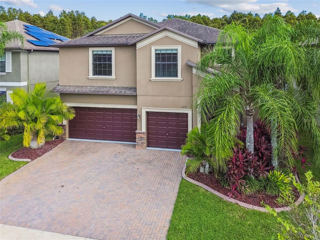 11737 Crestridge Loop New Port Richey, FL 34655 - Photo 79 of 100 a front view of a house with a yard