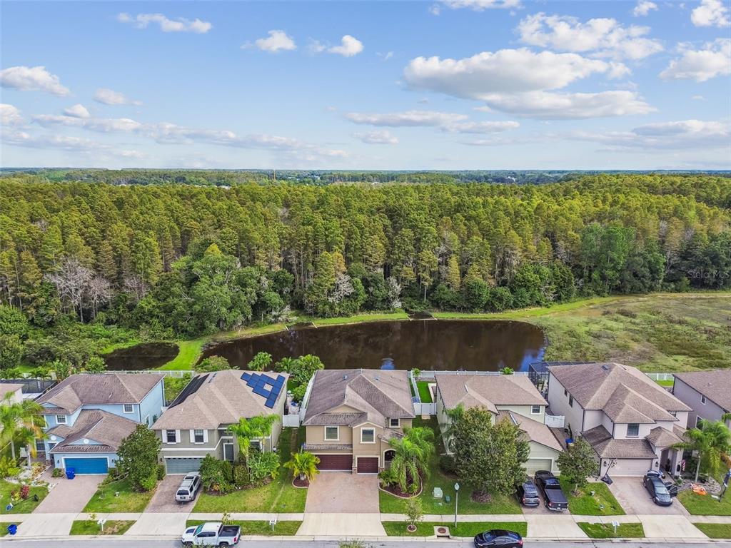11737 Crestridge Loop New Port Richey, FL 34655 - Photo 87 of 100 an aerial view of a house with a garden and lake view