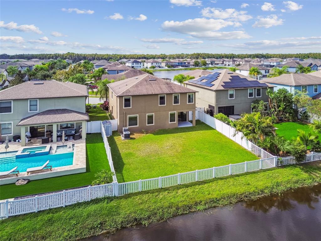 11737 Crestridge Loop New Port Richey, FL 34655 - Photo 98 of 100 a view of a house with a big yard and a large tree