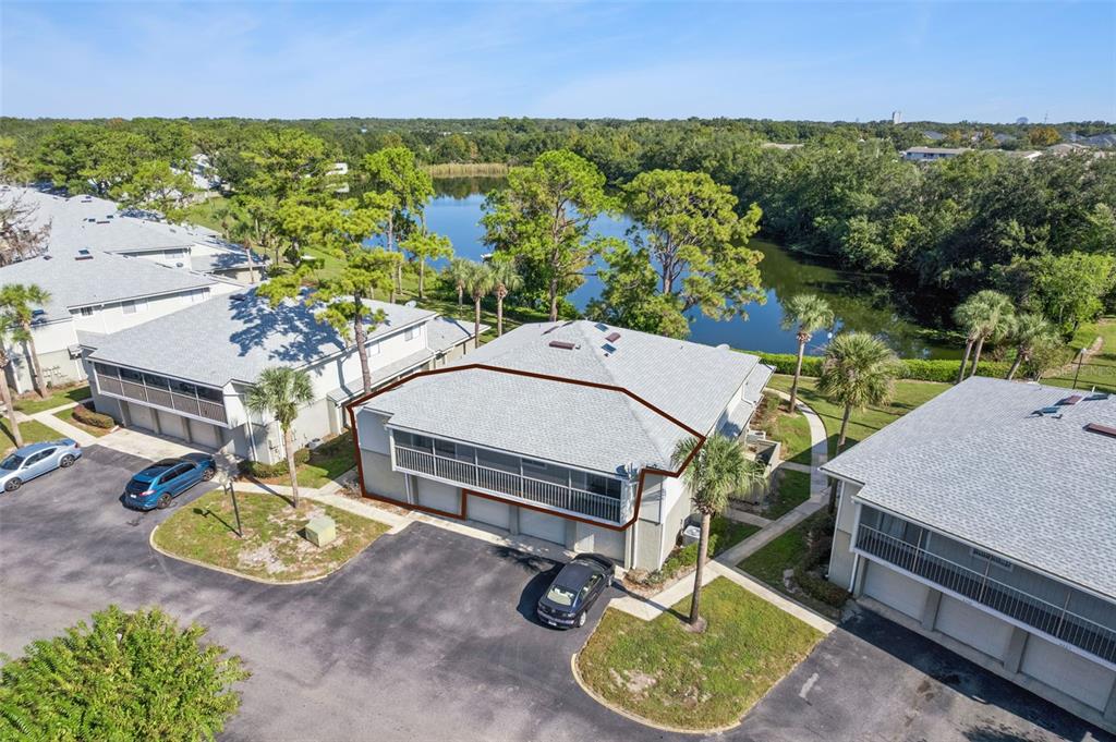 an aerial view of a house with garden space and street view