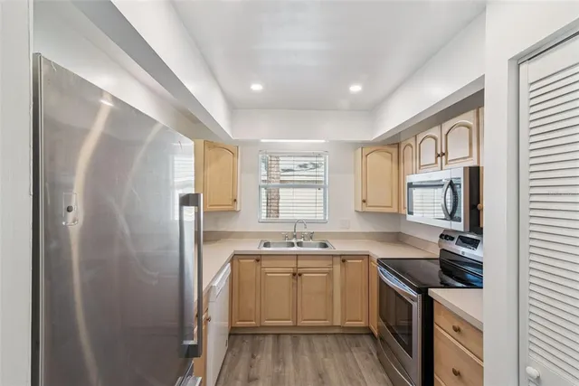 a kitchen with a sink stove and refrigerator