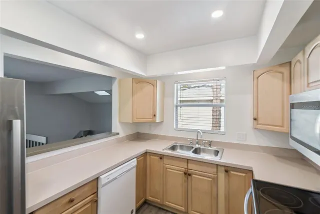 a kitchen with a sink cabinets and window
