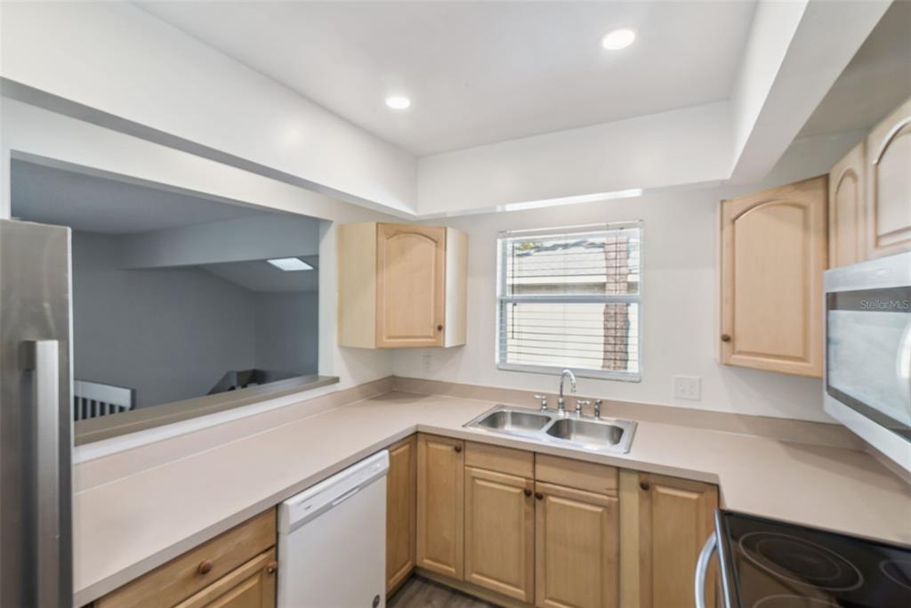 4449 Ring Neck Road, Unit C Orlando, FL 32808 - Photo 12 of 29 a kitchen with a sink cabinets and window