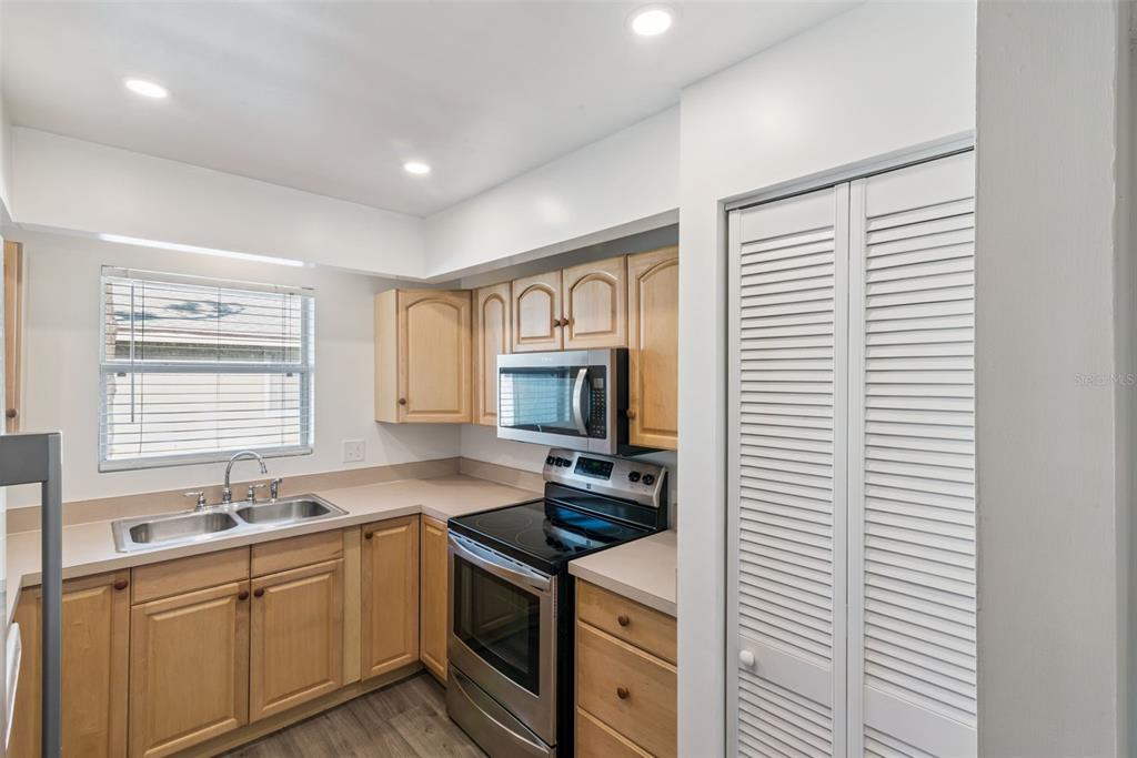4449 Ring Neck Road, Unit C Orlando, FL 32808 - Photo 13 of 29 a kitchen with a sink cabinets and window
