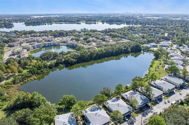 an aerial view of a city with lots of residential buildings lake and ocean view