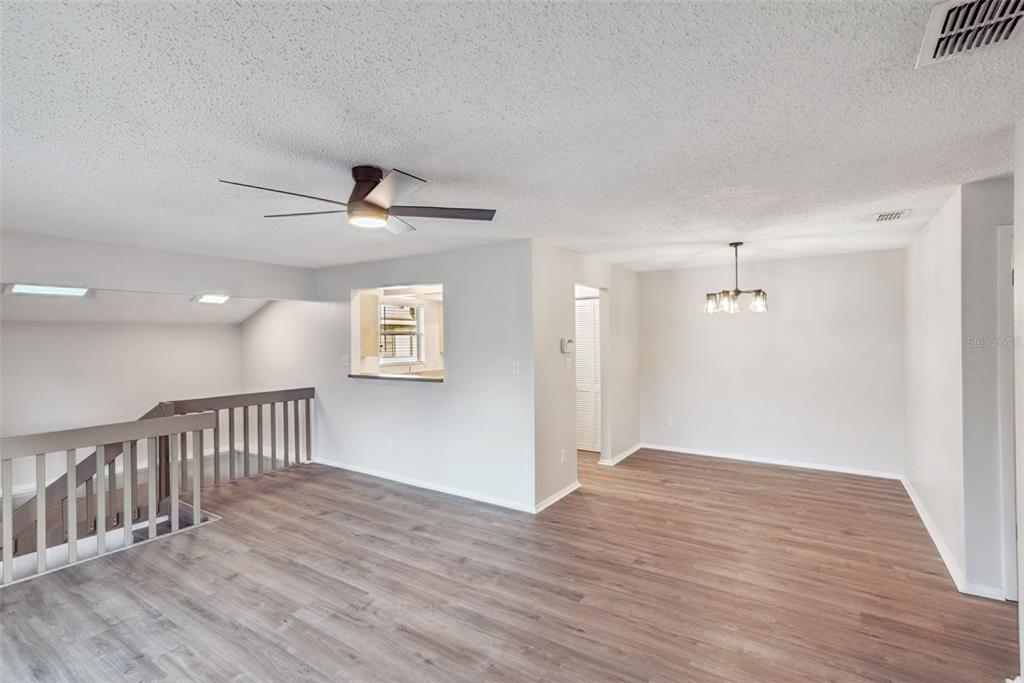 4449 Ring Neck Road, Unit C Orlando, FL 32808 - Photo 7 of 29 a view of an empty room with wooden floor