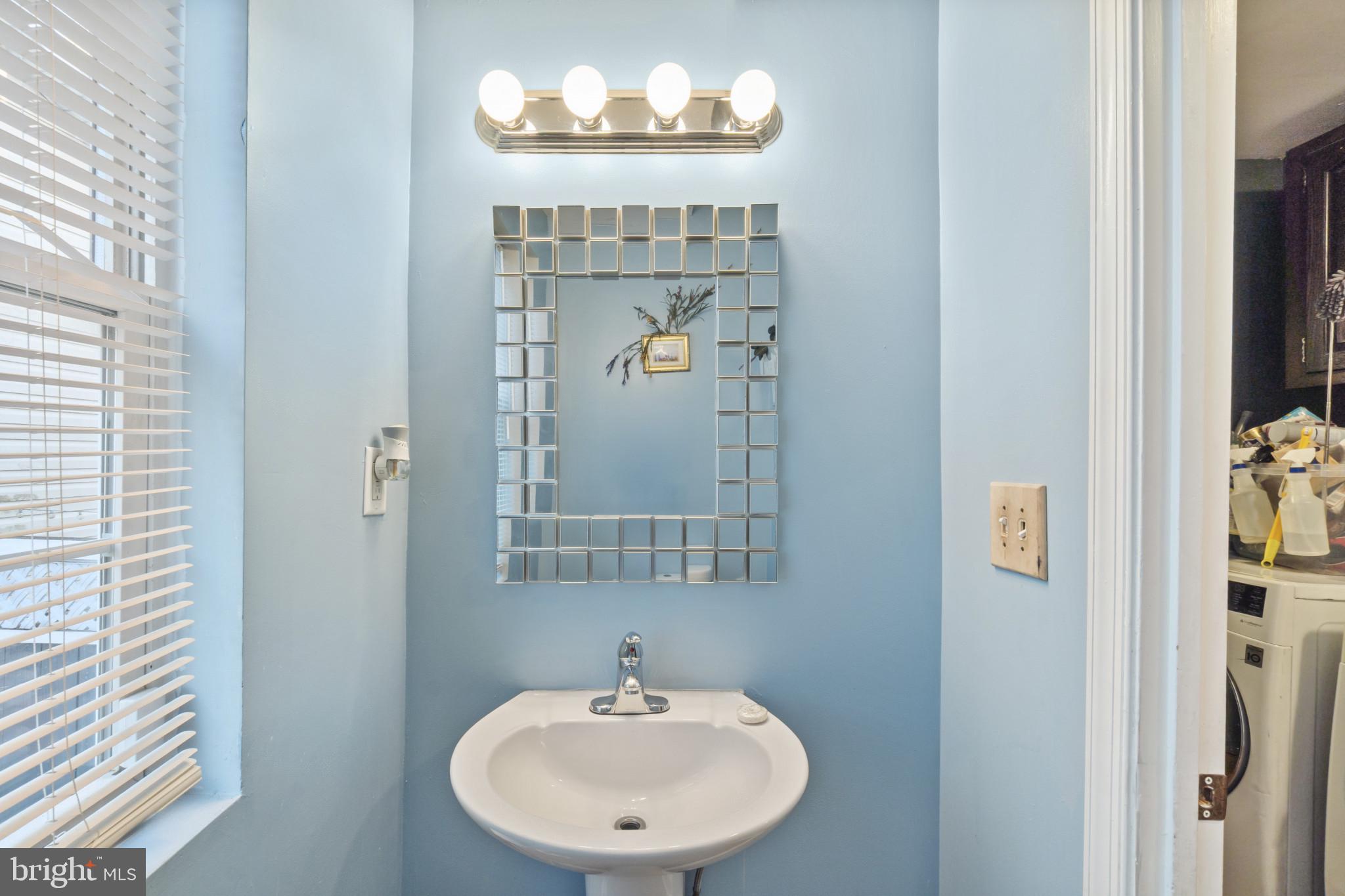 5904 Belle Grove Road Baltimore, MD 21225 - Photo 11 of 32 a bathroom with a sink and a mirror
