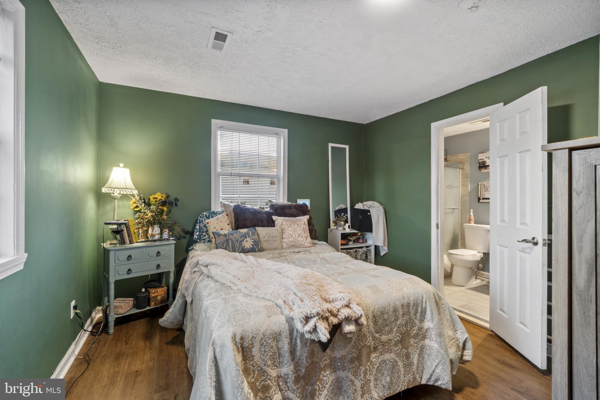5904 Belle Grove Road Baltimore, MD 21225 - Photo 13 of 32 a bedroom with a bed table closet and a window