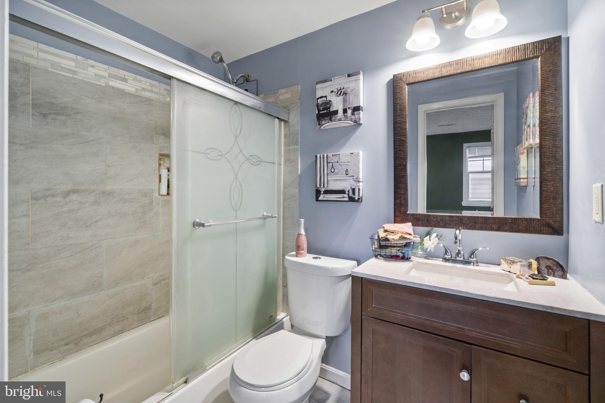 5904 Belle Grove Road Baltimore, MD 21225 - Photo 14 of 32 a bathroom with a sink a toilet and shower