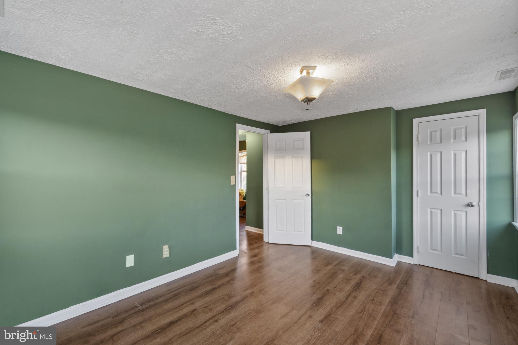 5904 Belle Grove Road Baltimore, MD 21225 - Photo 17 of 32 an empty room with wooden floor and closet