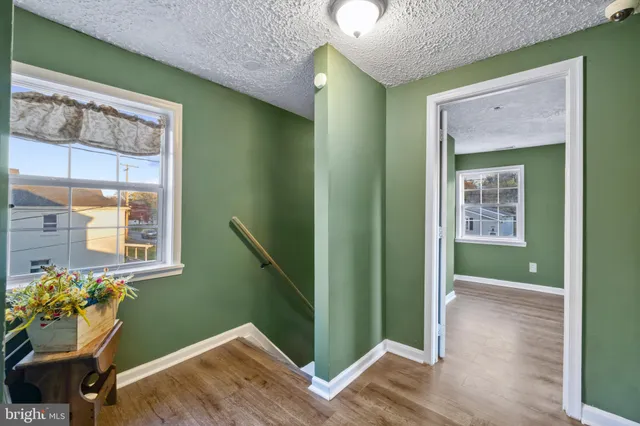 a view of an entryway with wooden floor