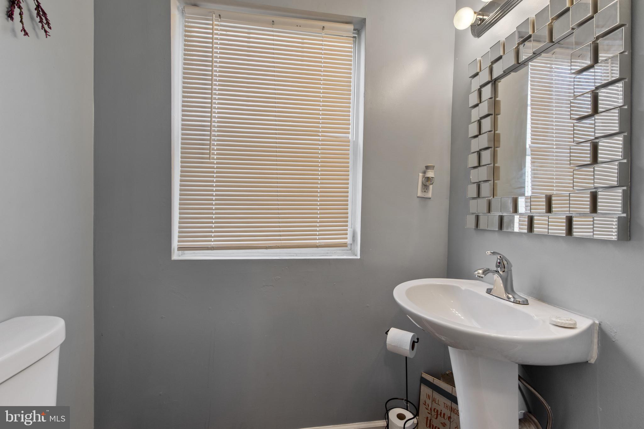 5904 Belle Grove Road Baltimore, MD 21225 - Photo 19 of 32 a bathroom with a sink and a toilet