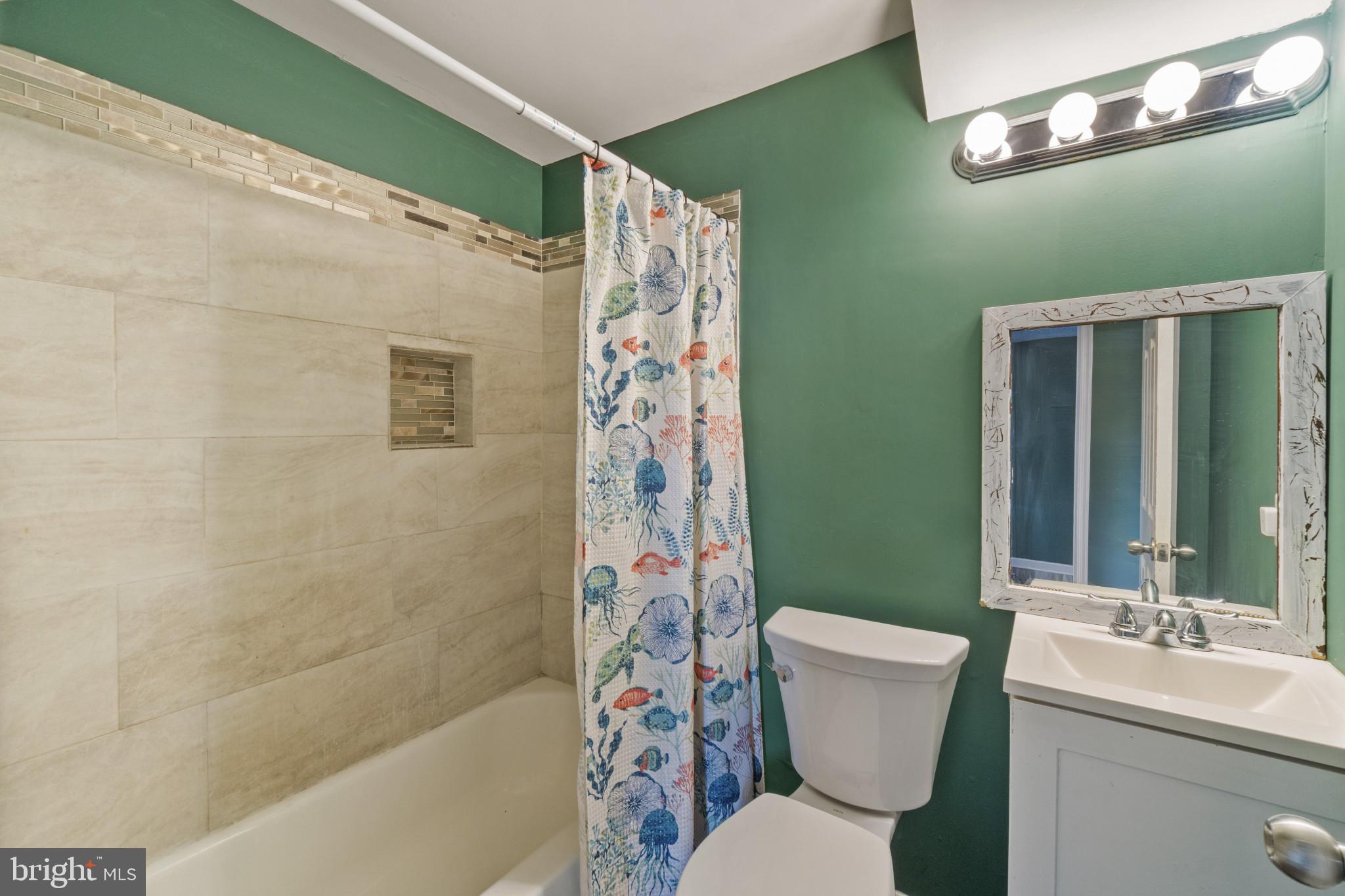 5904 Belle Grove Road Baltimore, MD 21225 - Photo 22 of 32 a bathroom with a toilet sink and mirror