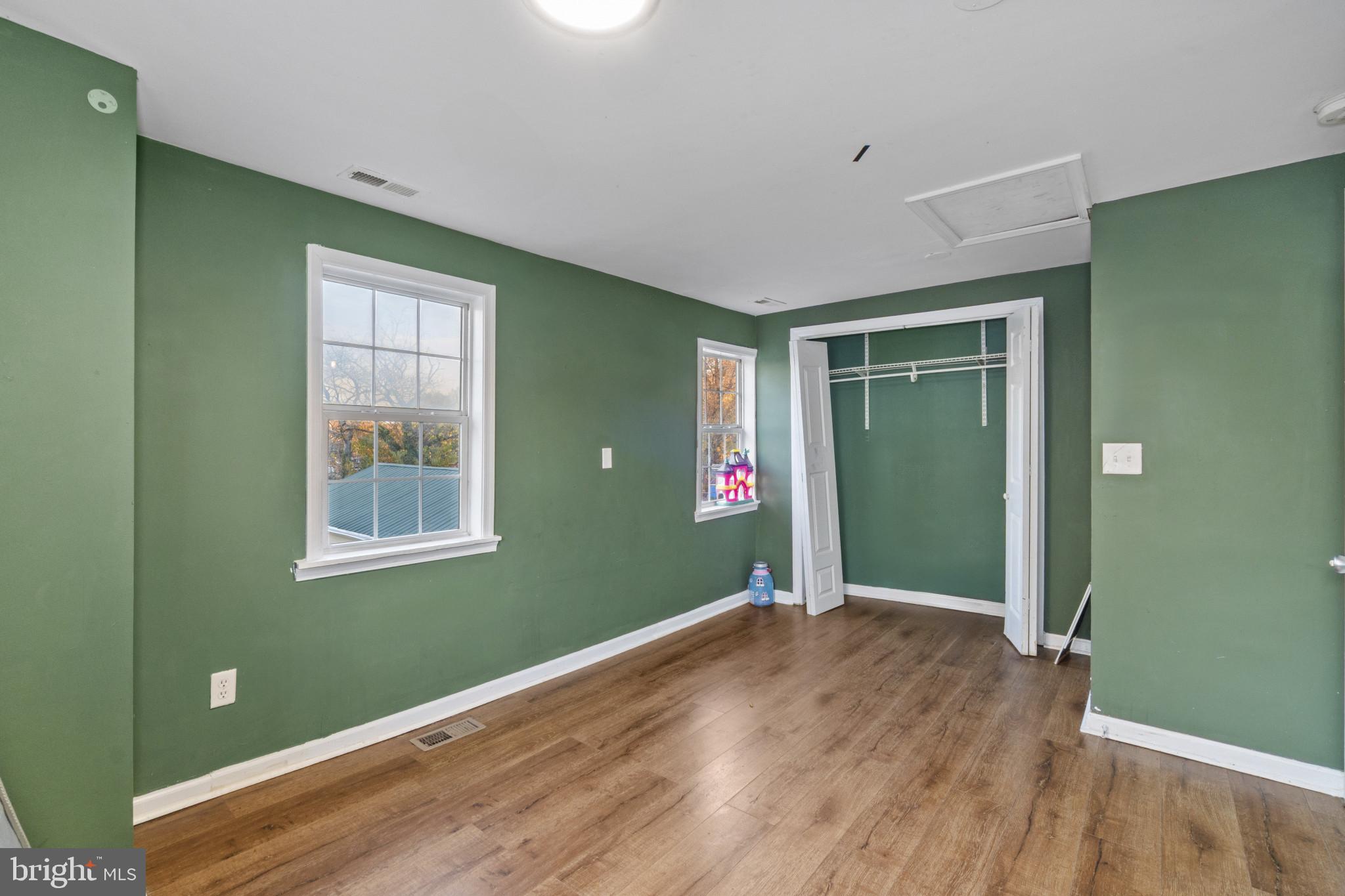 5904 Belle Grove Road Baltimore, MD 21225 - Photo 23 of 32 a view of empty room with window and wooden floor