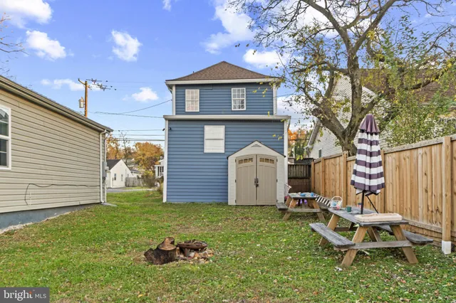 a view of a chair and table in backyard of the house