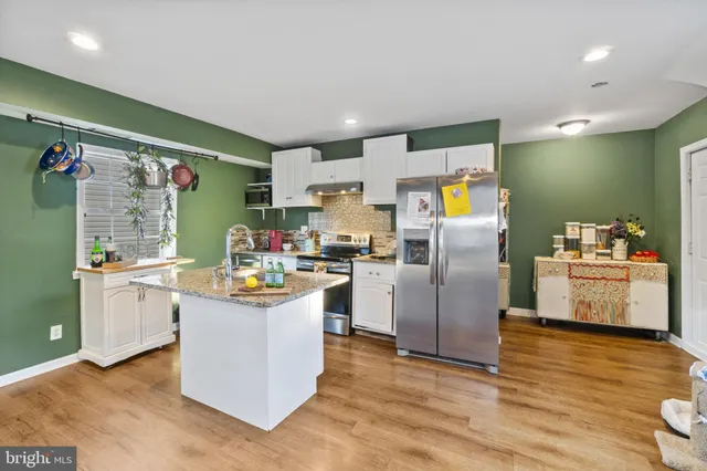 a kitchen with refrigerator and cabinets