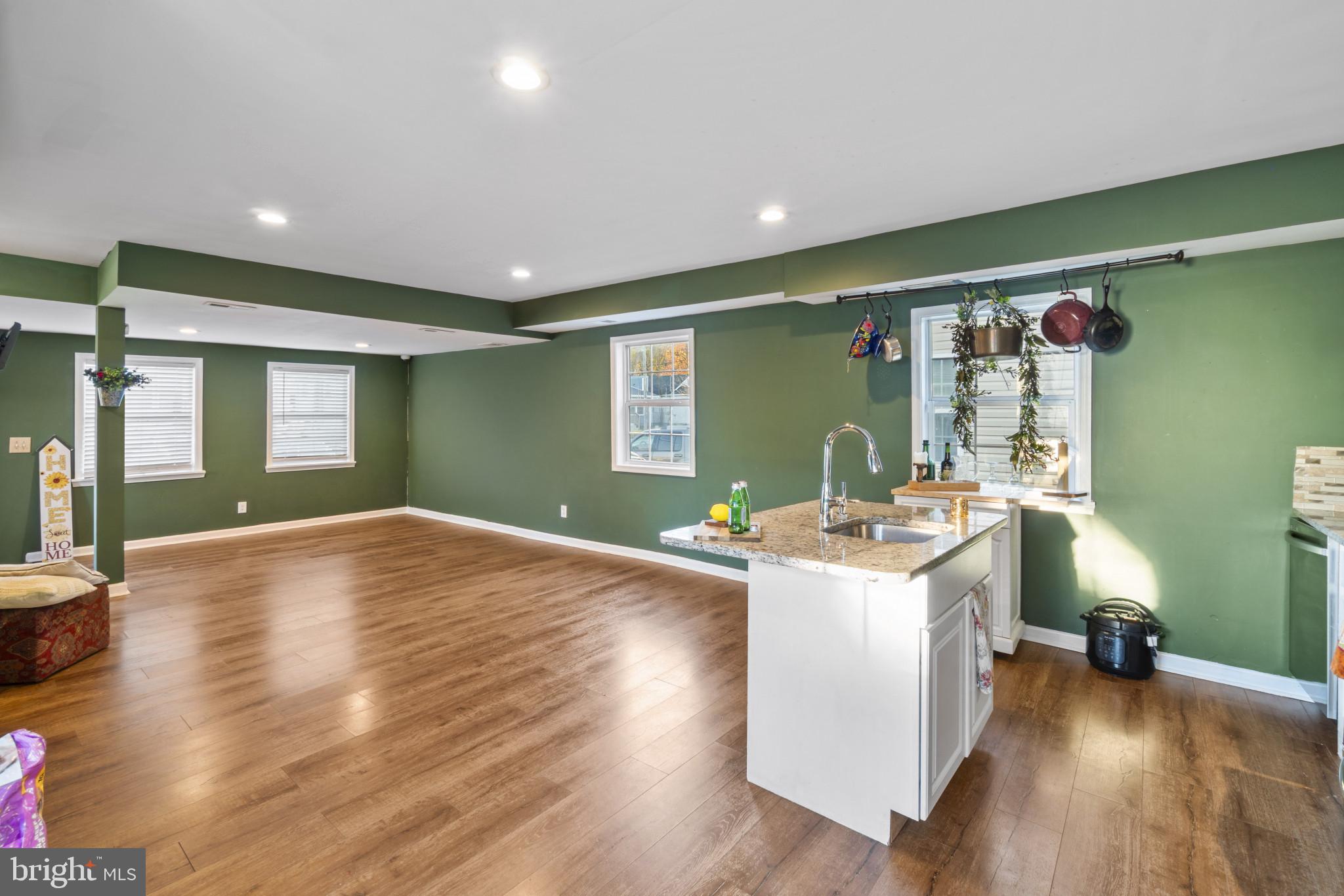 5904 Belle Grove Road Baltimore, MD 21225 - Photo 6 of 32 a view of a livingroom with furniture hardwood floor and workspace