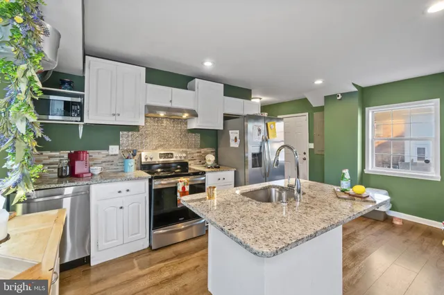 a kitchen with stainless steel appliances granite countertop a sink dishwasher and stove