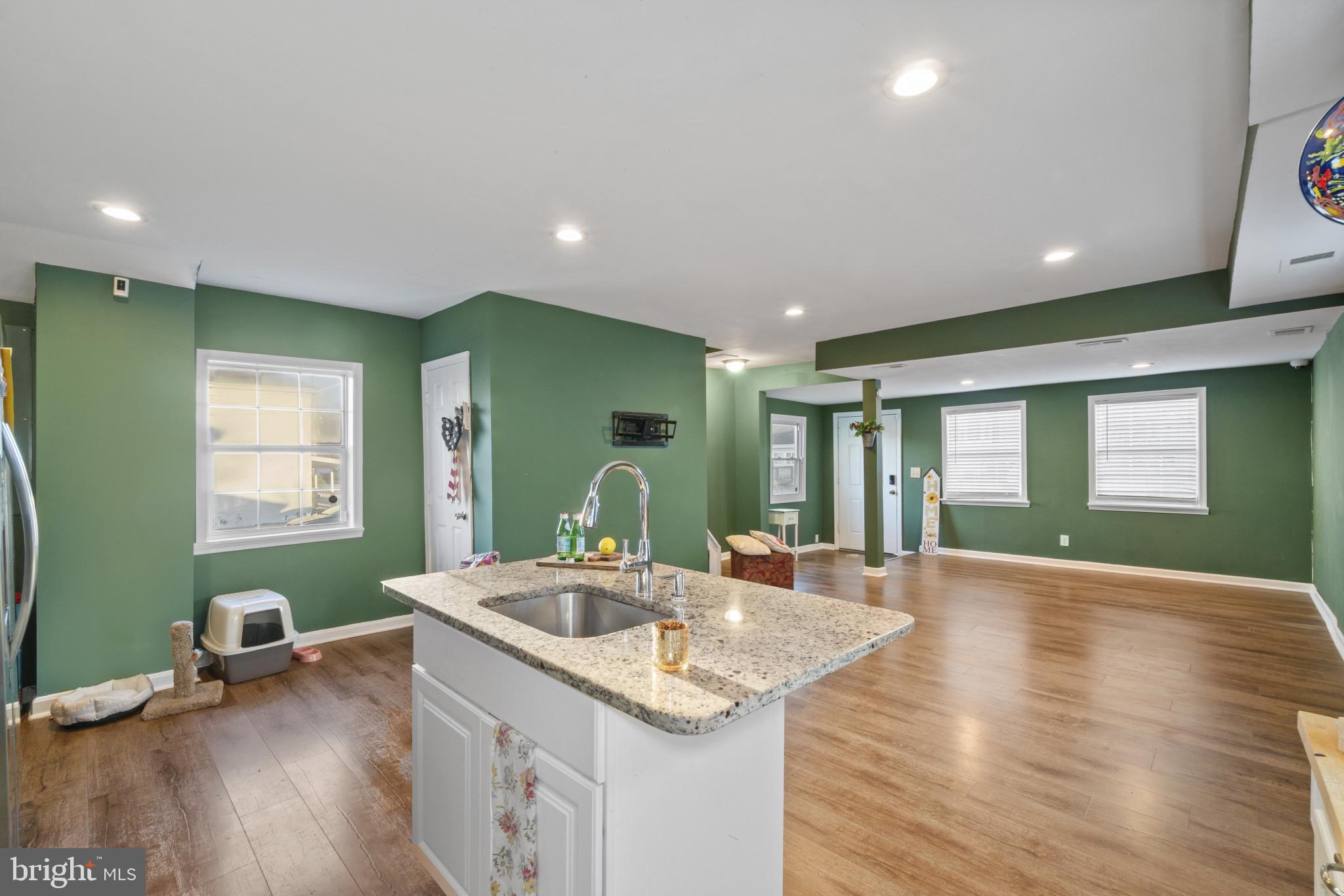 5904 Belle Grove Road Baltimore, MD 21225 - Photo 8 of 32 a kitchen with sink and view of living room