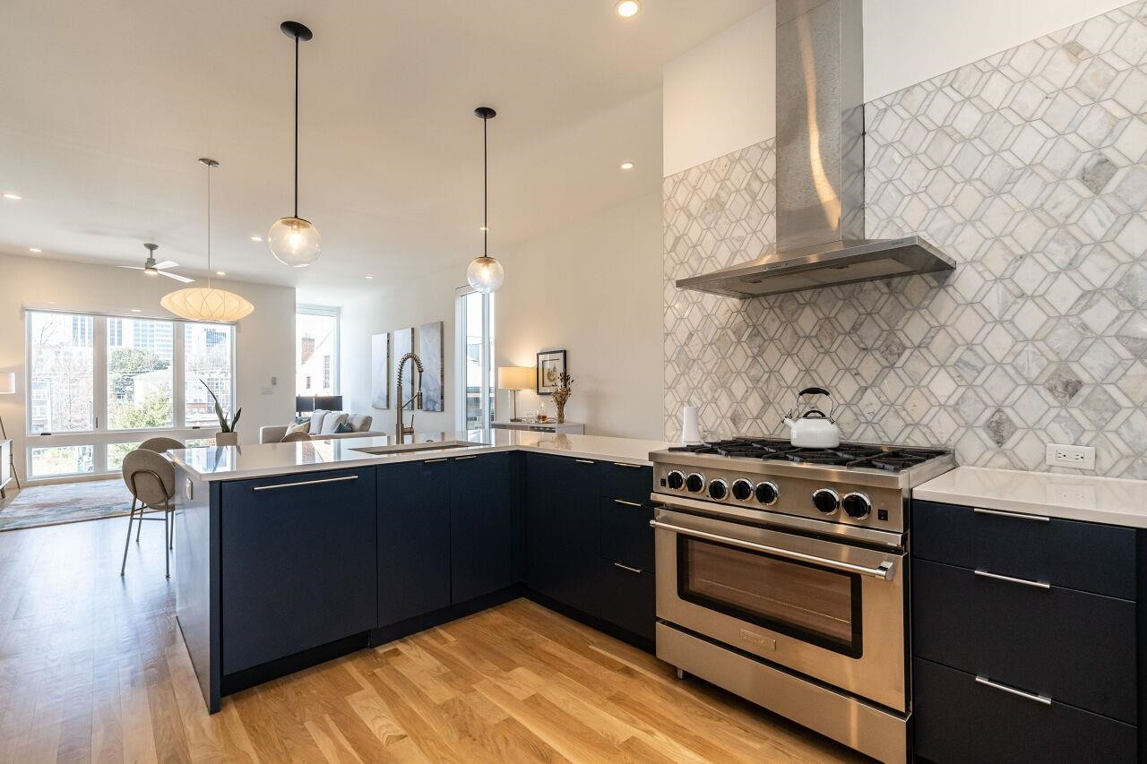 424 Chavis Way Raleigh, NC 27601 - Photo 8 of 23 a kitchen with a stove and a wooden floor