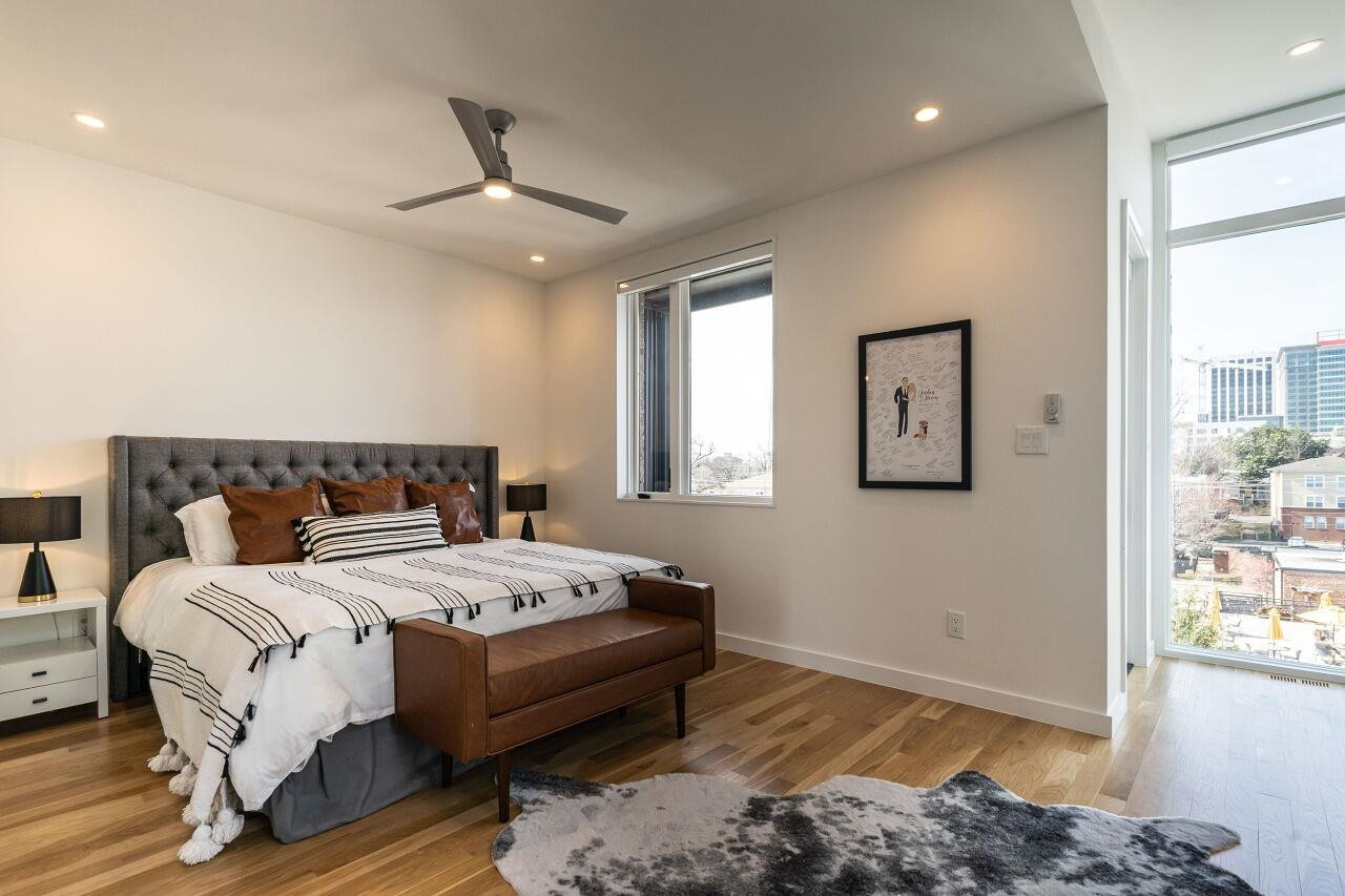 424 Chavis Way Raleigh, NC 27601 - Photo 10 of 23 a bedroom with a bed and wooden floor
