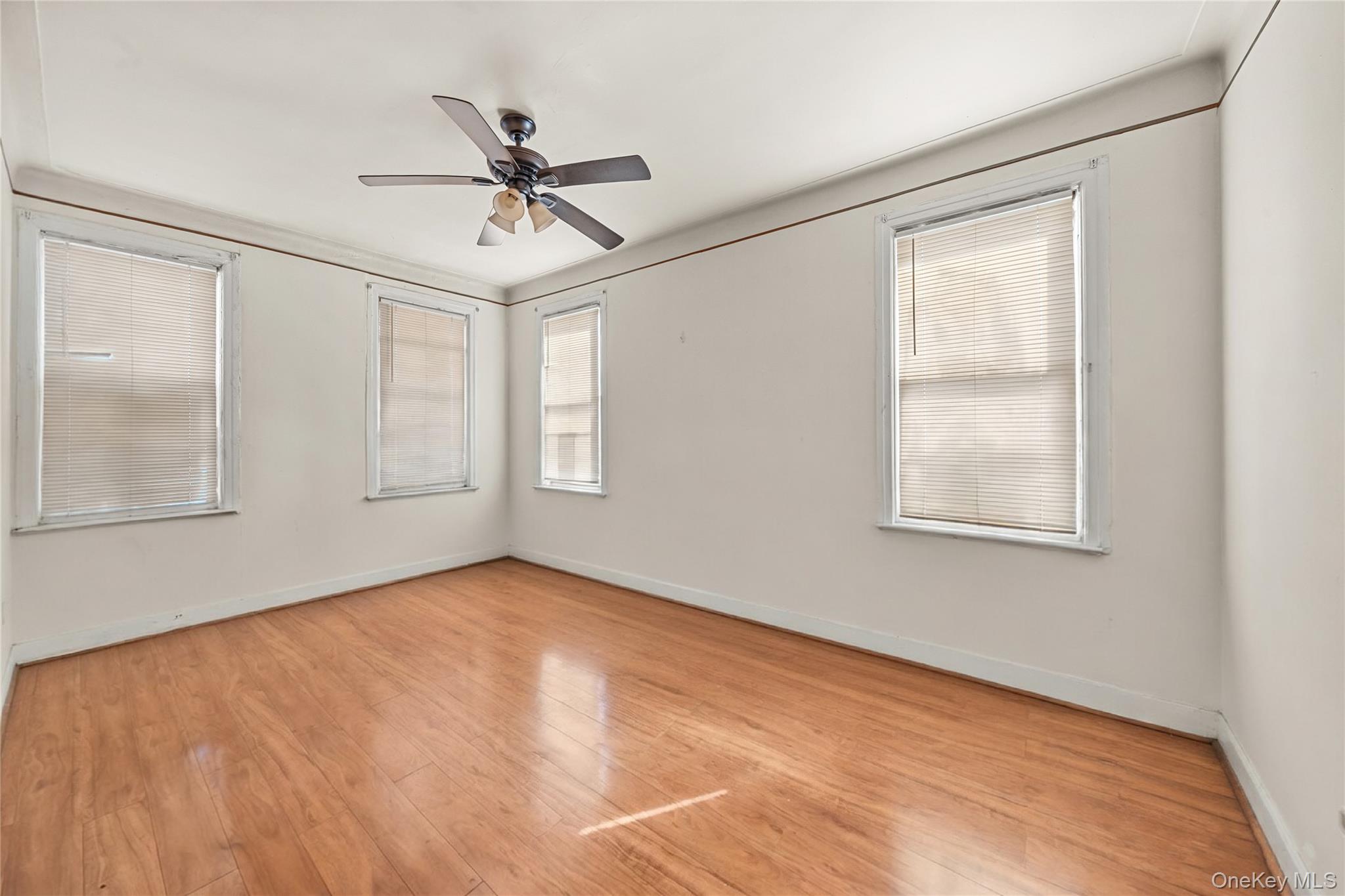 39-27 57th Street Queens, NY 11377 - Photo 17 of 35 a view of a room with wooden floor fan and windows