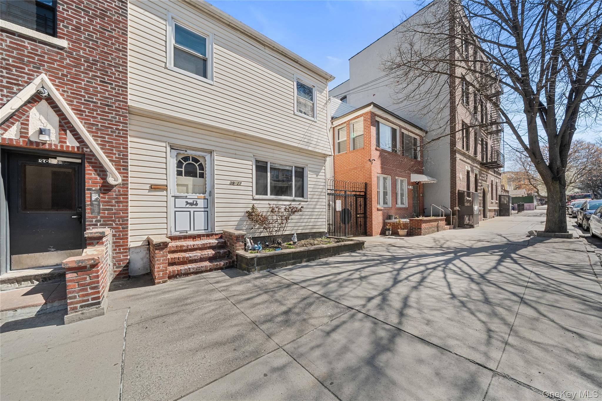 39-27 57th Street Queens, NY 11377 - Photo 29 of 35 a view of a house with a snow on the road