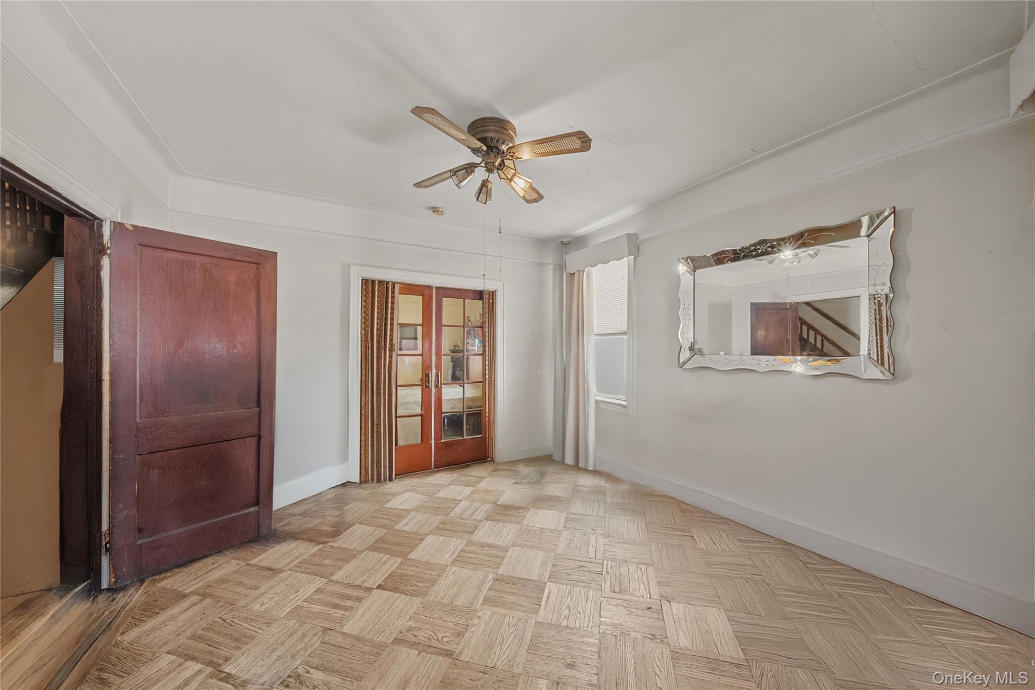 39-27 57th Street Queens, NY 11377 - Photo 8 of 35 a view of a livingroom with a chandelier fan and windows
