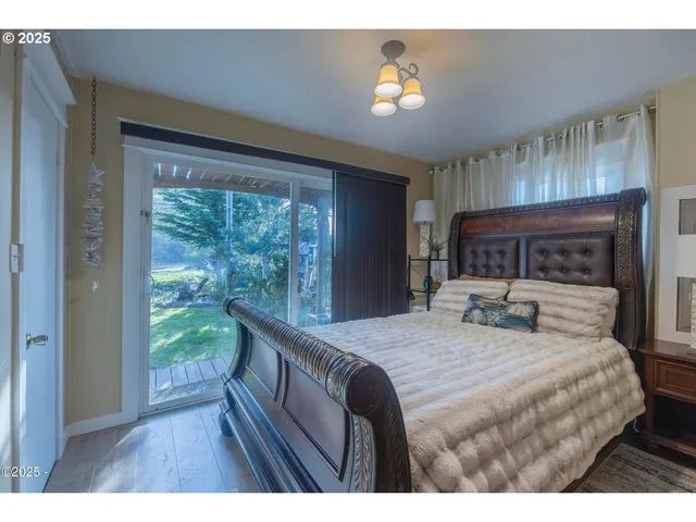 a living room with a bed furniture and a large window