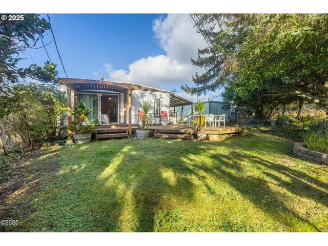 a view of an house with backyard and patio