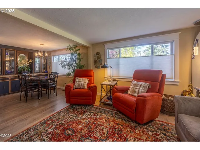 a living room with furniture a dining table and a fireplace