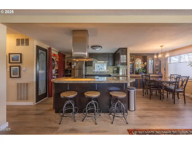 a dining room with furniture a chandelier and window