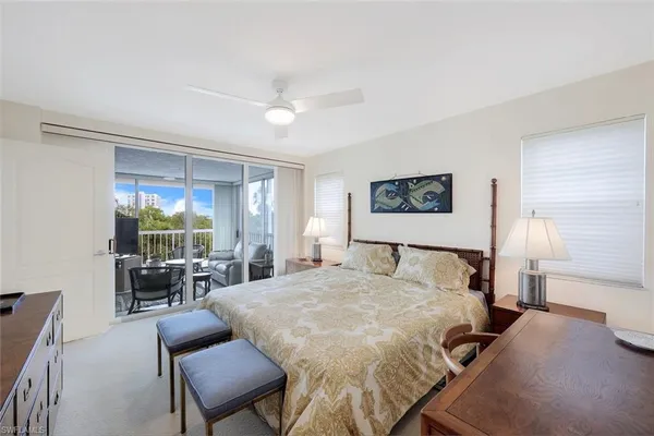 a large bedroom with a bed and large windows