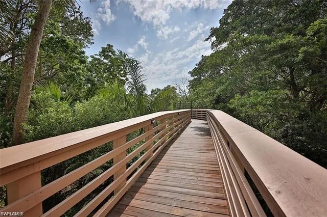 a view of a balcony with wooden floor and fence
