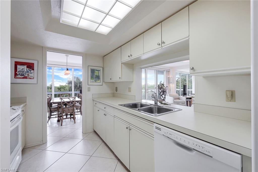 5501 Heron Point Drive, Unit 204 Naples, FL 34108 - Photo 8 of 23 a kitchen with a sink and cabinets
