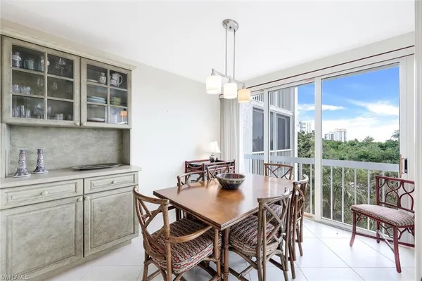 a view of a dining room with furniture window and outside view