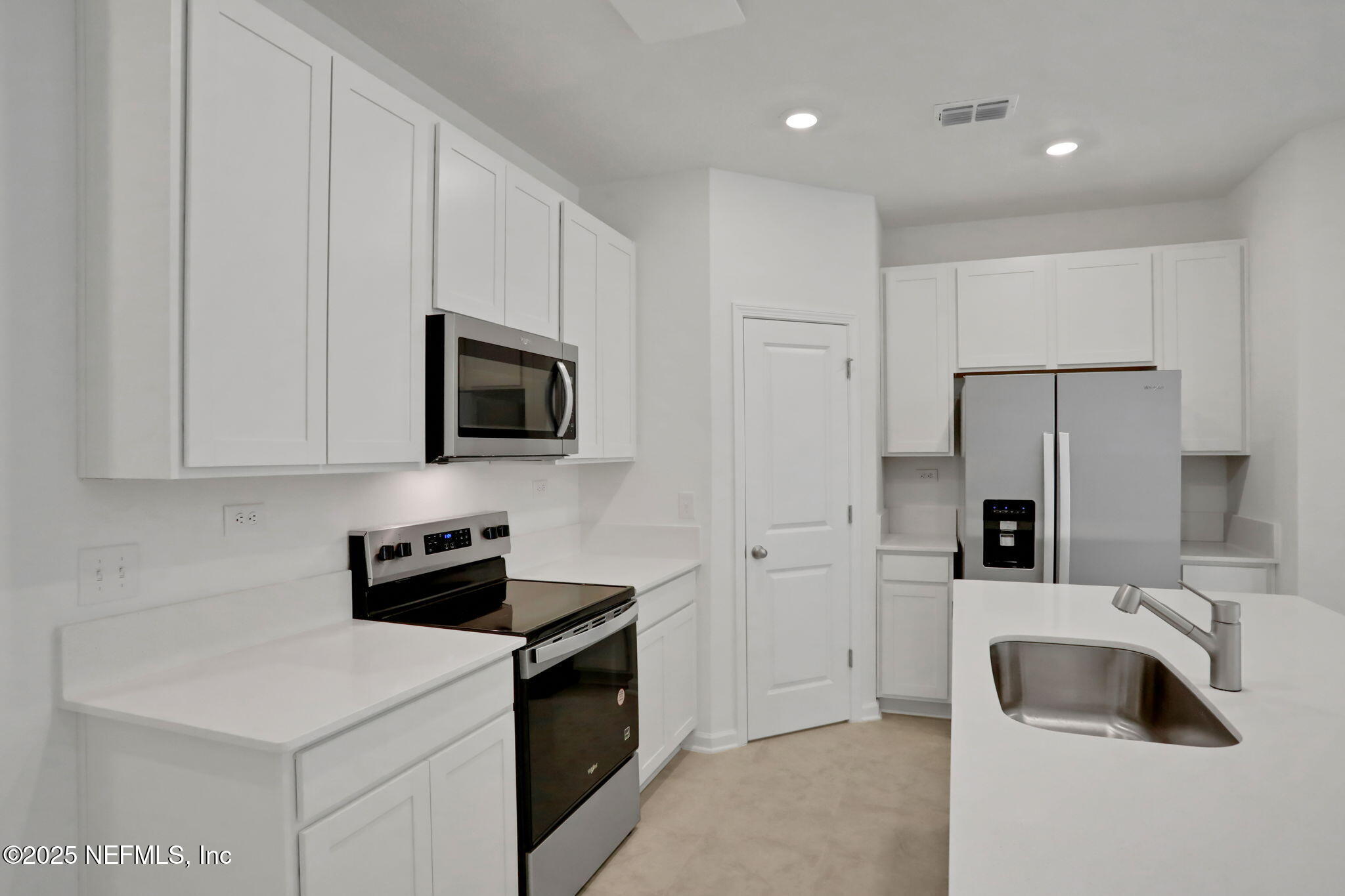 3765 Athenian Way Middleburg, FL 32068 - Photo 35 of 61 a kitchen with stainless steel appliances a refrigerator sink and microwave