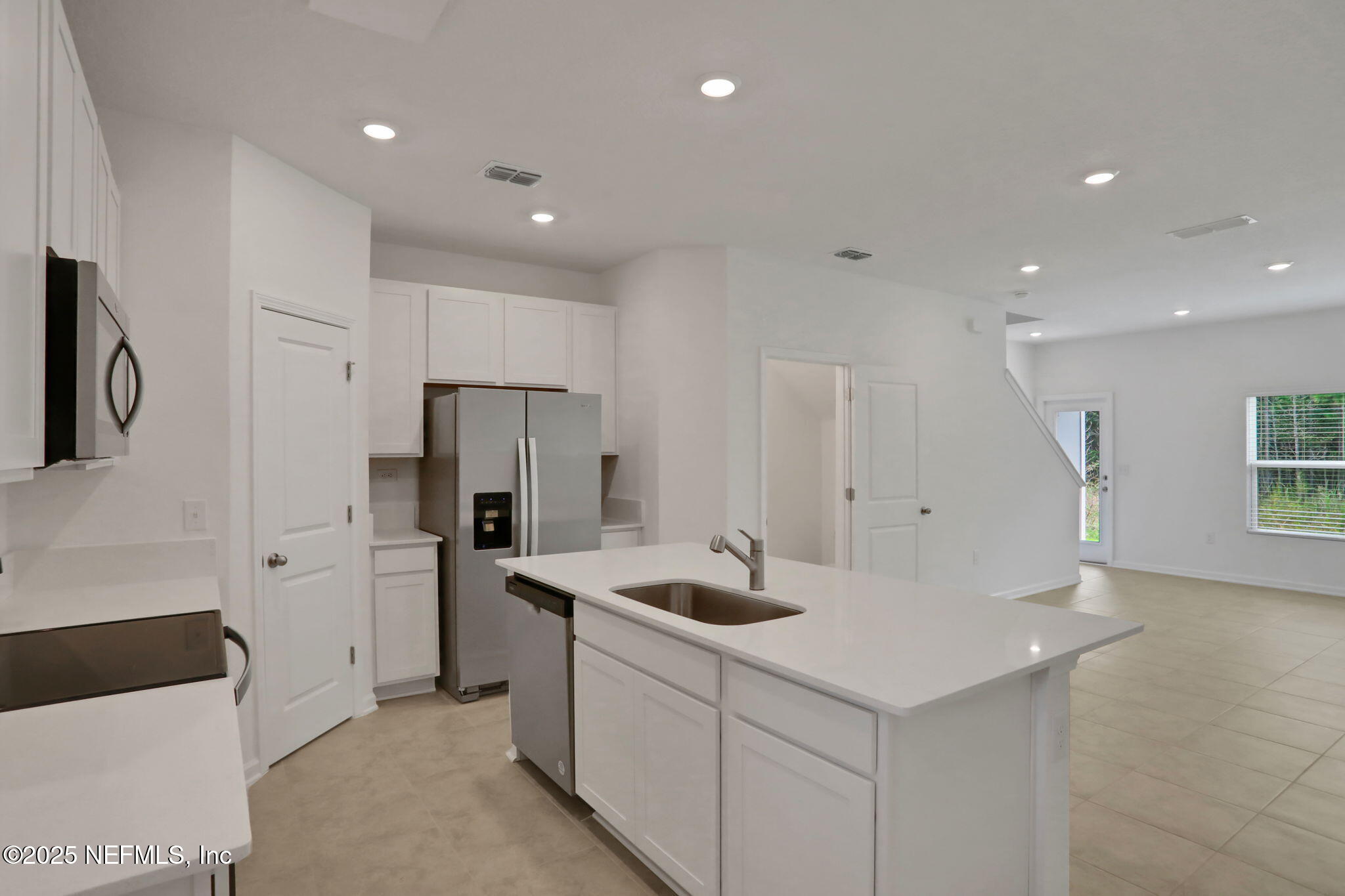 3765 Athenian Way Middleburg, FL 32068 - Photo 37 of 61 a kitchen with white cabinets and stainless steel appliances